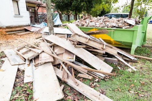 Workers wearing PPE during waste removal at an office site
